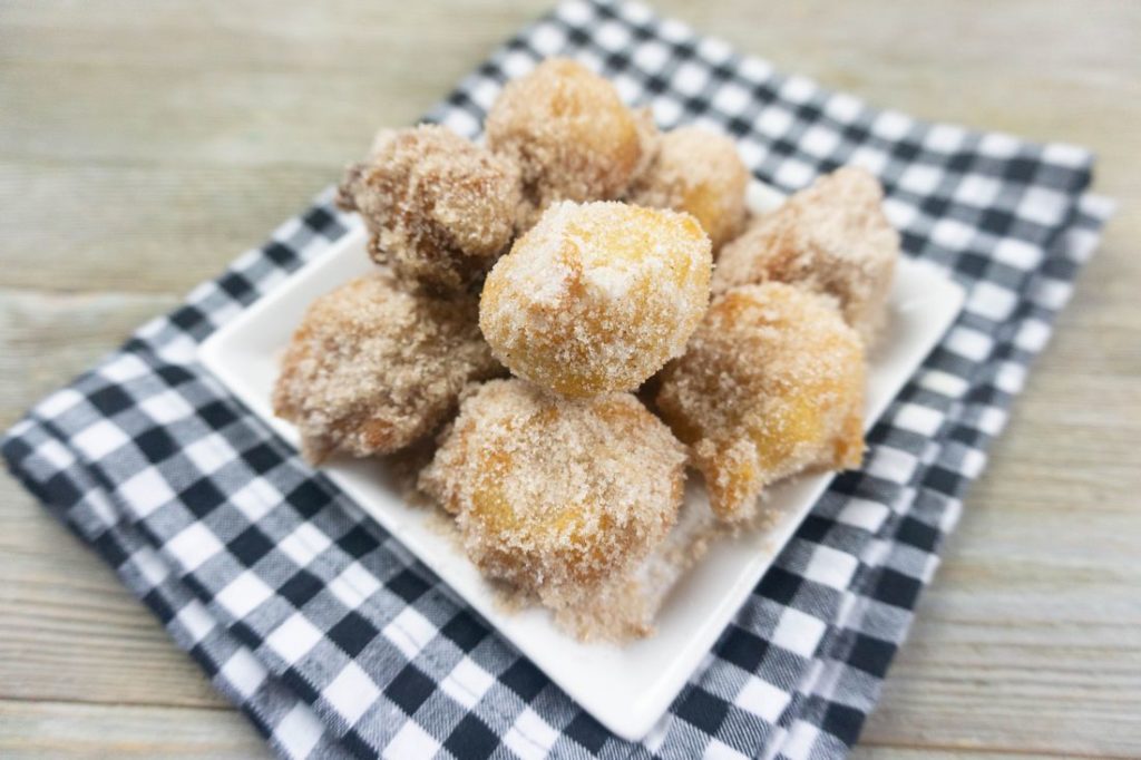 Deep Fried Bananas on a small white late with black and white plaid napkin