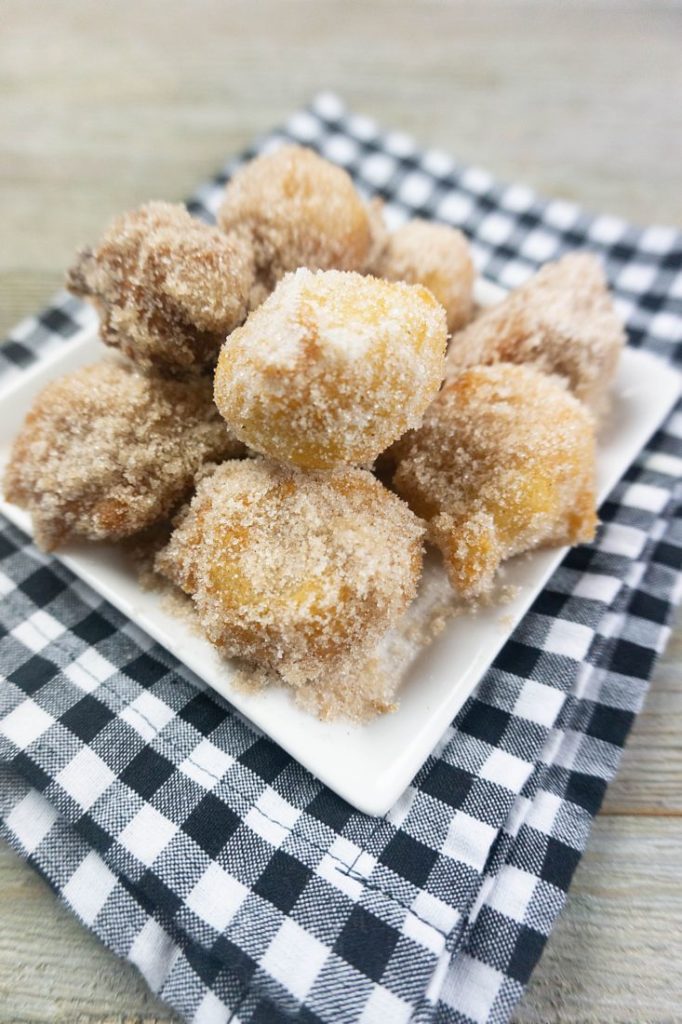 Deep Fried Bananas on a small white late with black and white plaid napkin