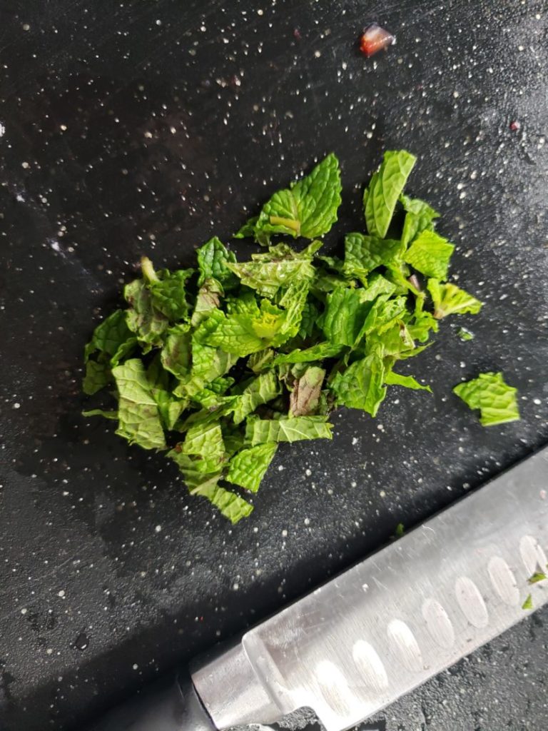 Mint on a black cutting board