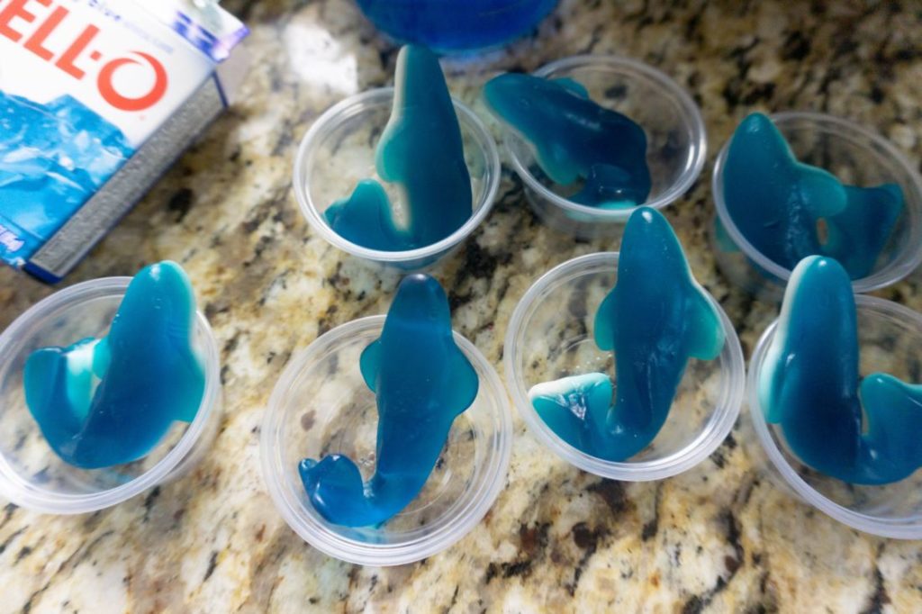 Blue gummy sharks in jello shot cups