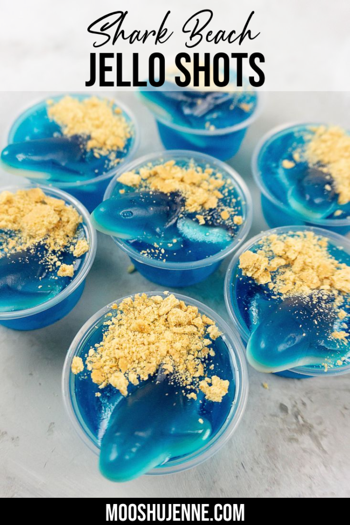 Shark Beach Jello Shots with gummy sharks, graham crackers as sand, and blue jello.