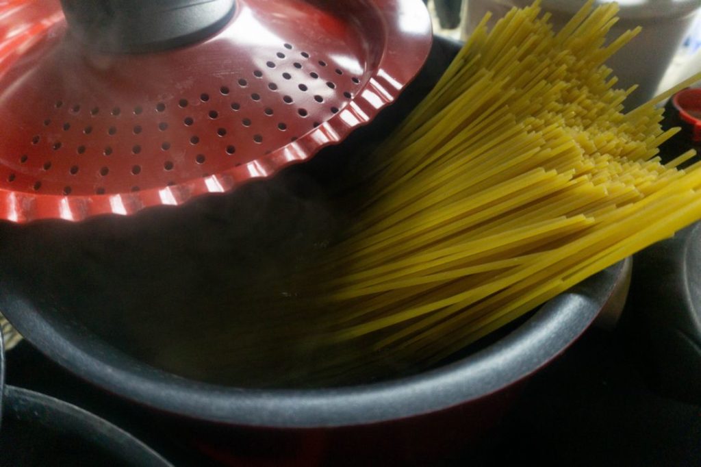 Pasta in a red pot with water