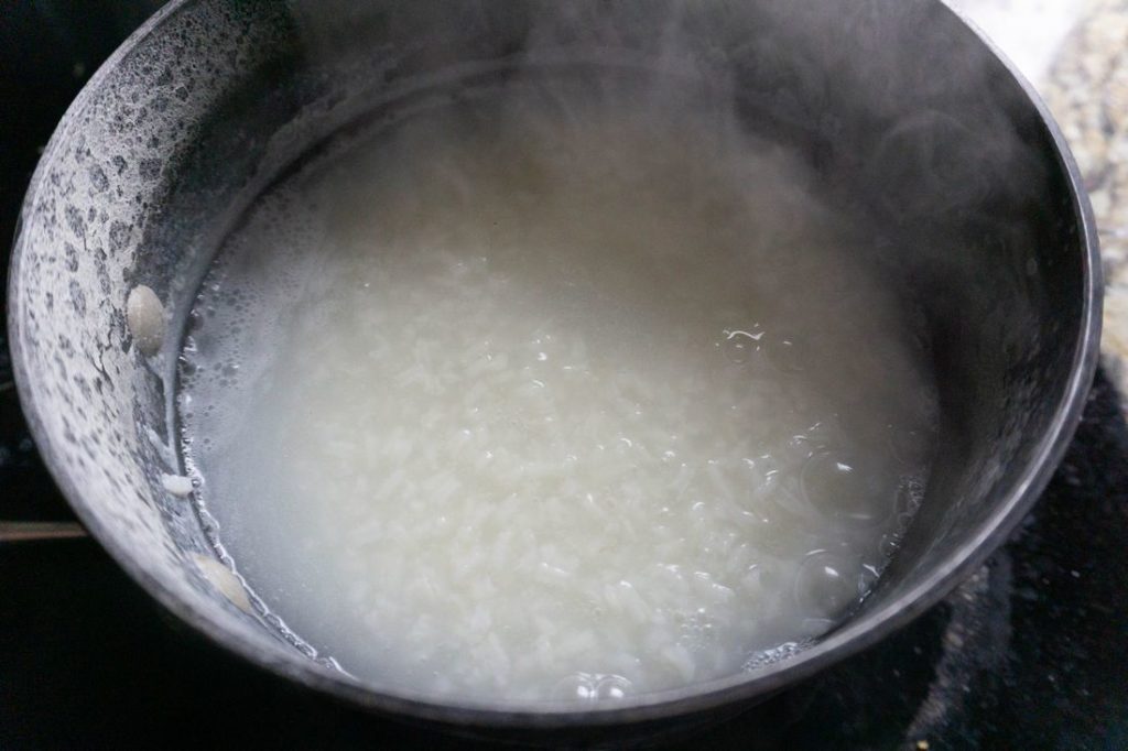 Raya Congee rice in pot with water boiling