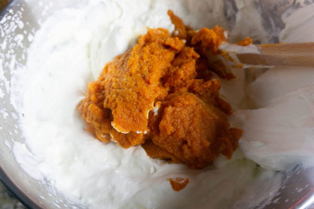 Pumpkin with whipped heavy cream in a stand mixer