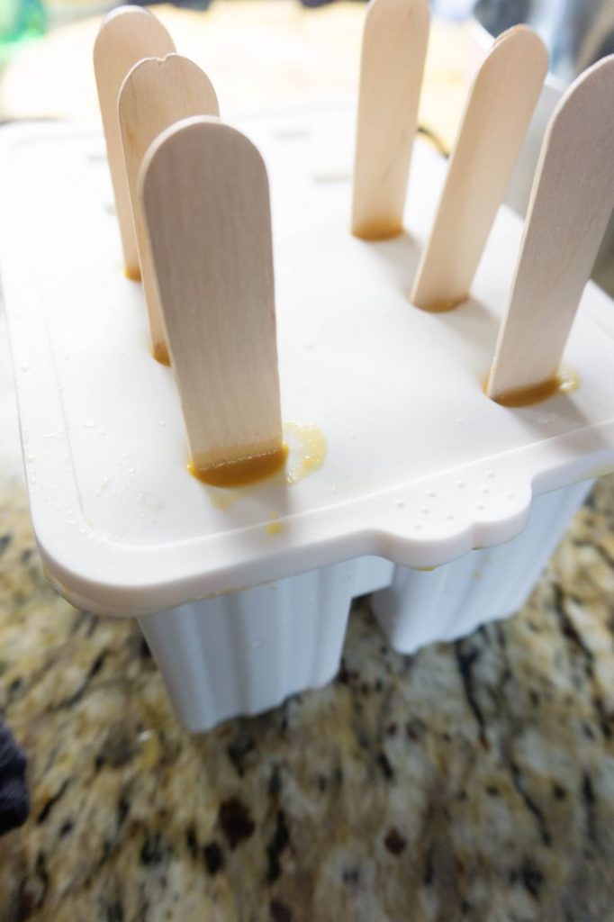 Pumpkin Latte Popsicles in the white silicone pop mold with wood sticks.