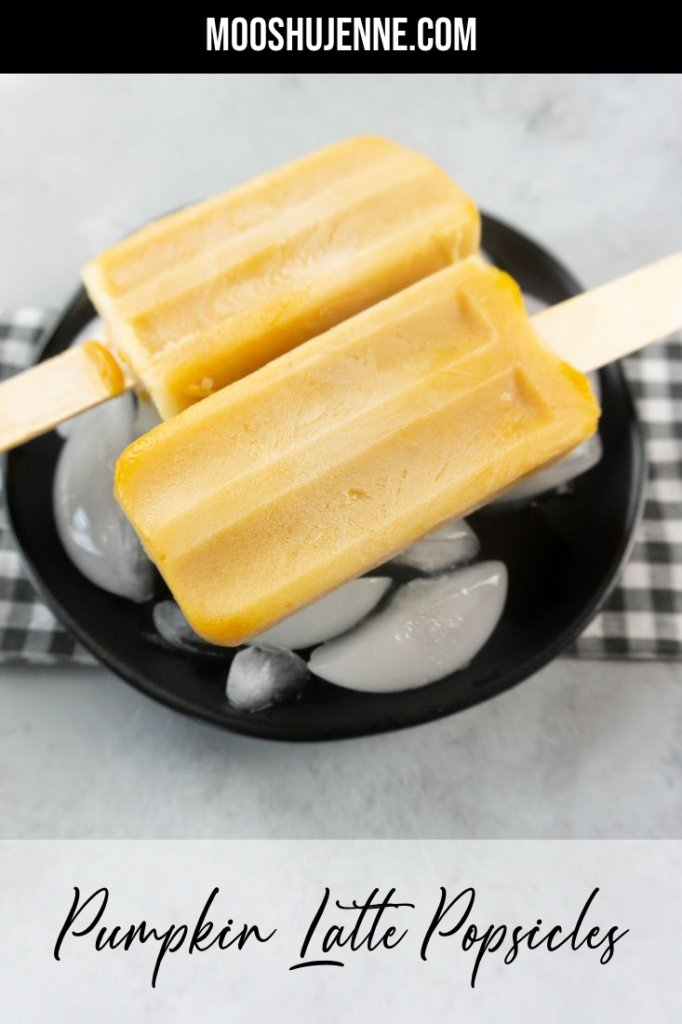 Pumpkin Latte Popsicles on a black plate with gray plaid napkin on a concrete backdrop