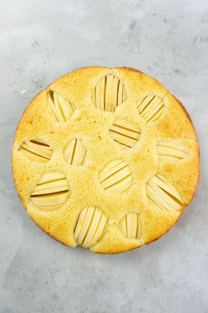 German Apple Coffee Cake with sliced apples on a concrete gray back drop