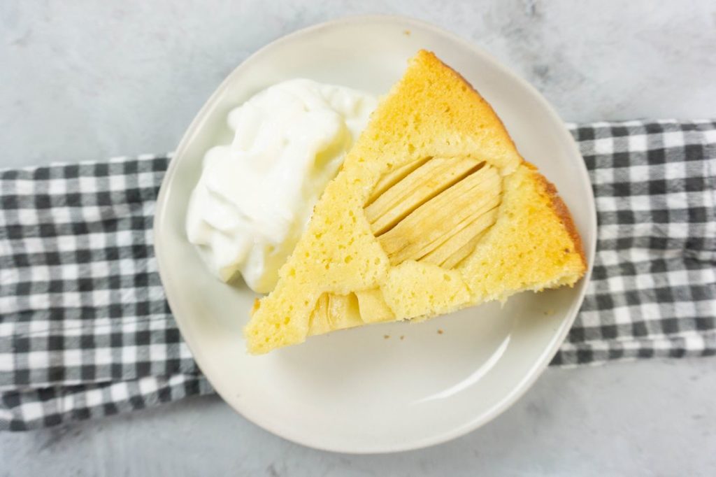 German Apple Coffee Cake with sliced apples on a concrete gray back drop