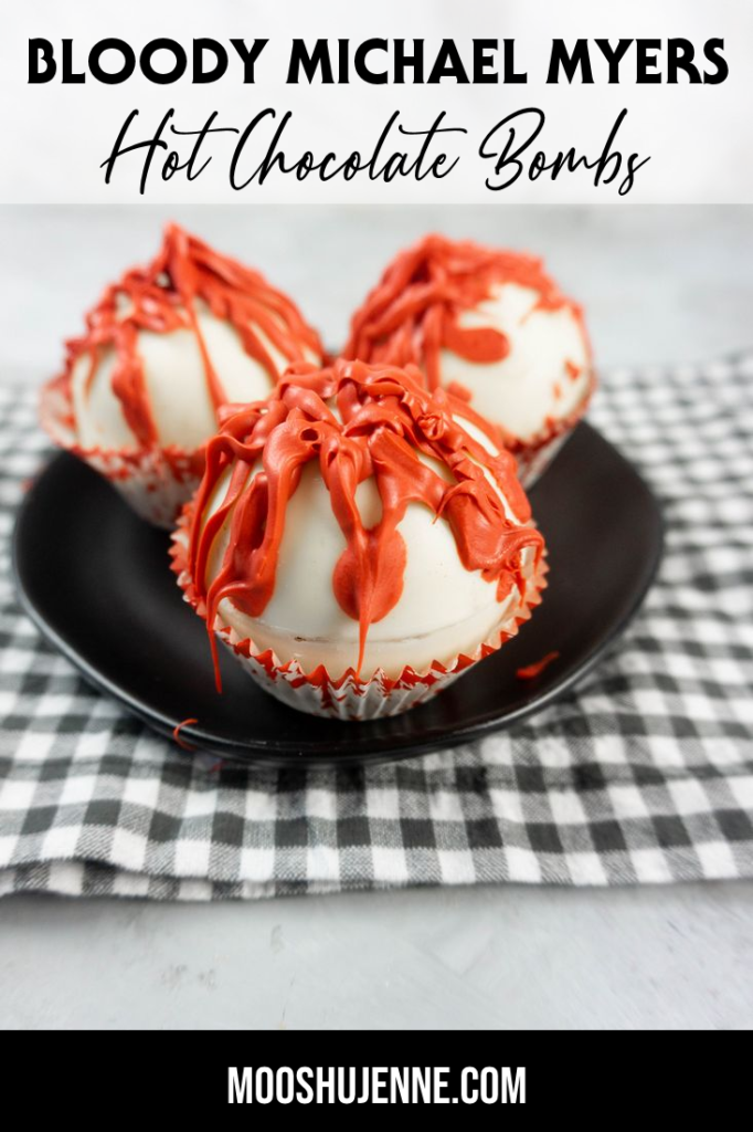 Bloody Michael Myers Hot Chocolate Bombs on black plate with plaid napkin and concrete back drop