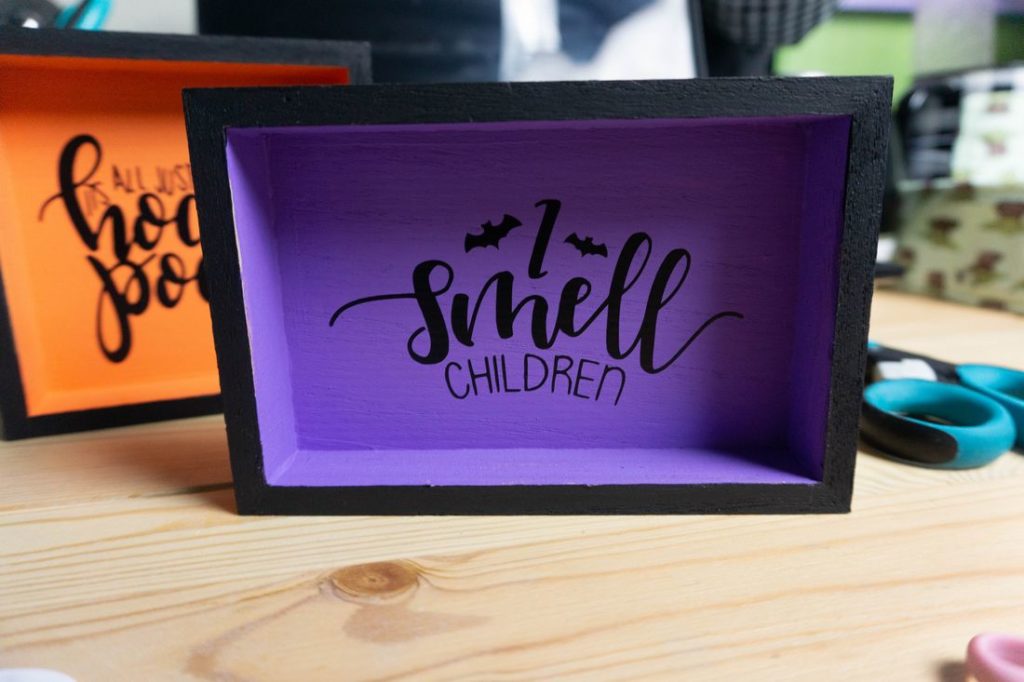 Orange and Purple wood square signs with I smelll children and it's just a bunch of hocus pocus 