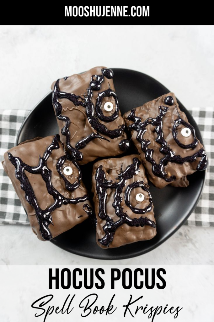 Hocus Pocus Spell Book Krispies on a black plate with grey plaid napkin on a concrete backdrop