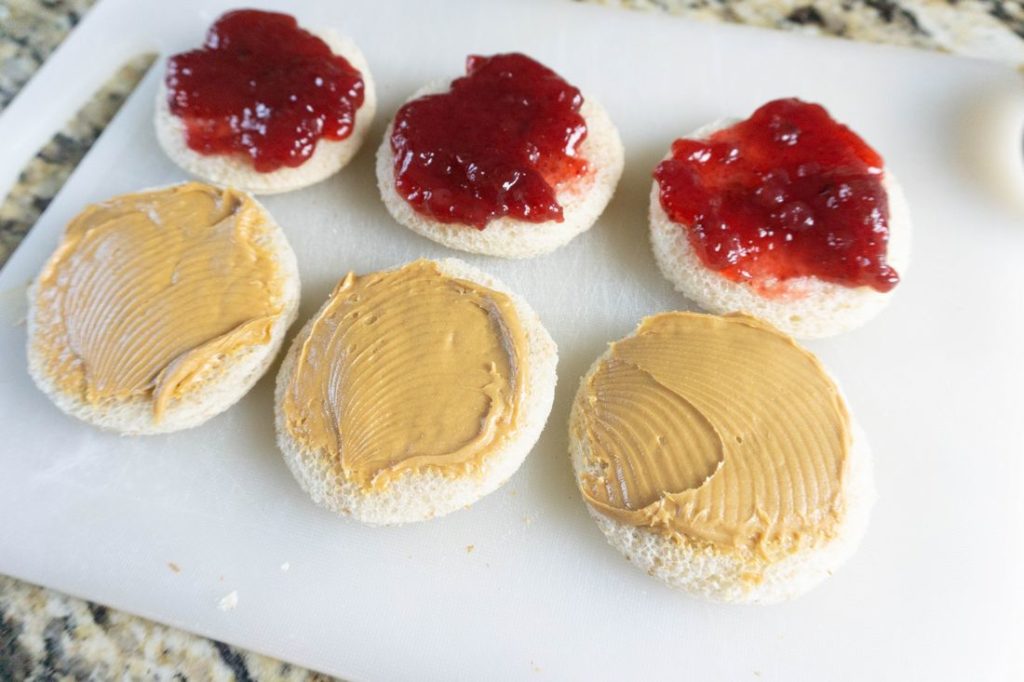 Bread cut with a biscuit cutter with peanut butter and jelly