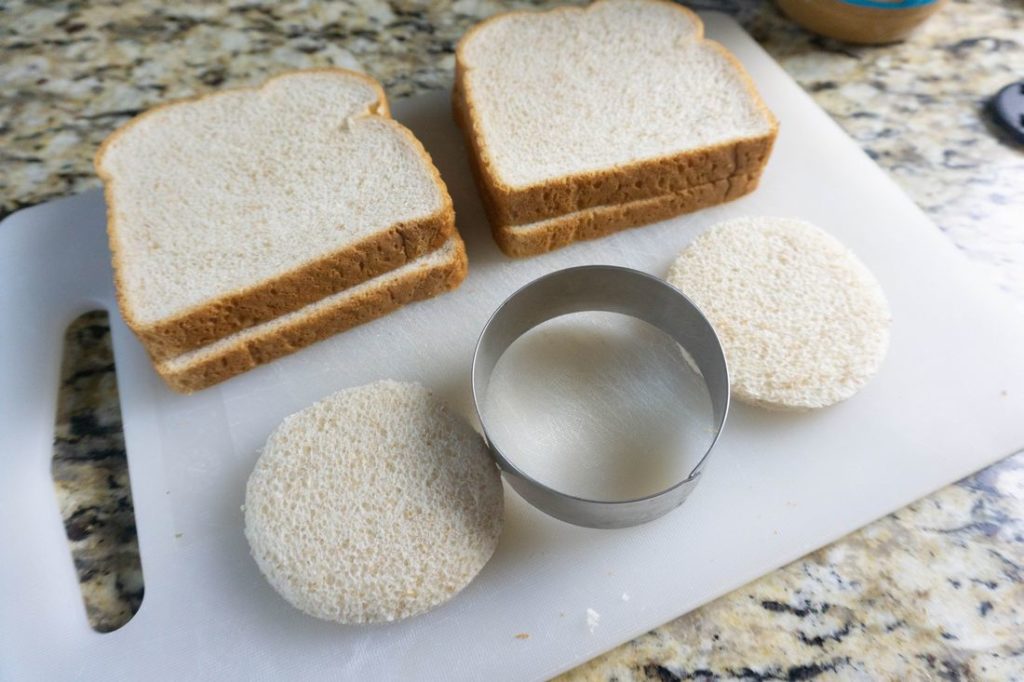 Bread cut with a biscuit cutter on a cutting board