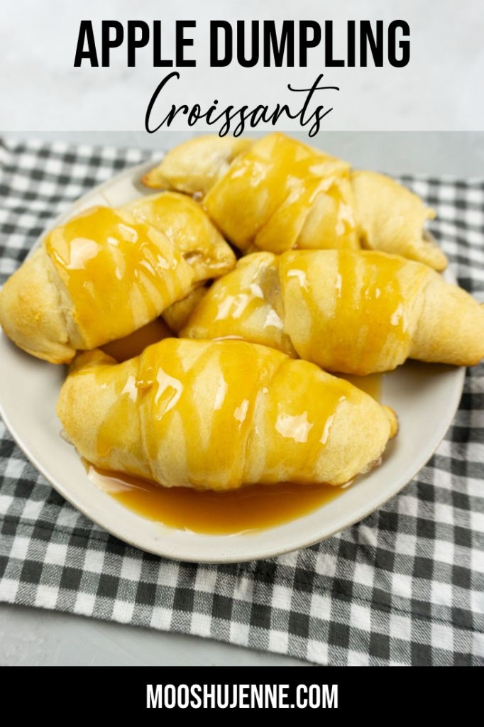 Apple Dumpling Croissants on a white plate with caramel drizzle with white and gray napkin on a concrete backdrop