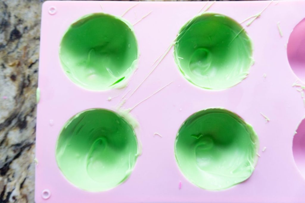 green candy melts in the pink mold