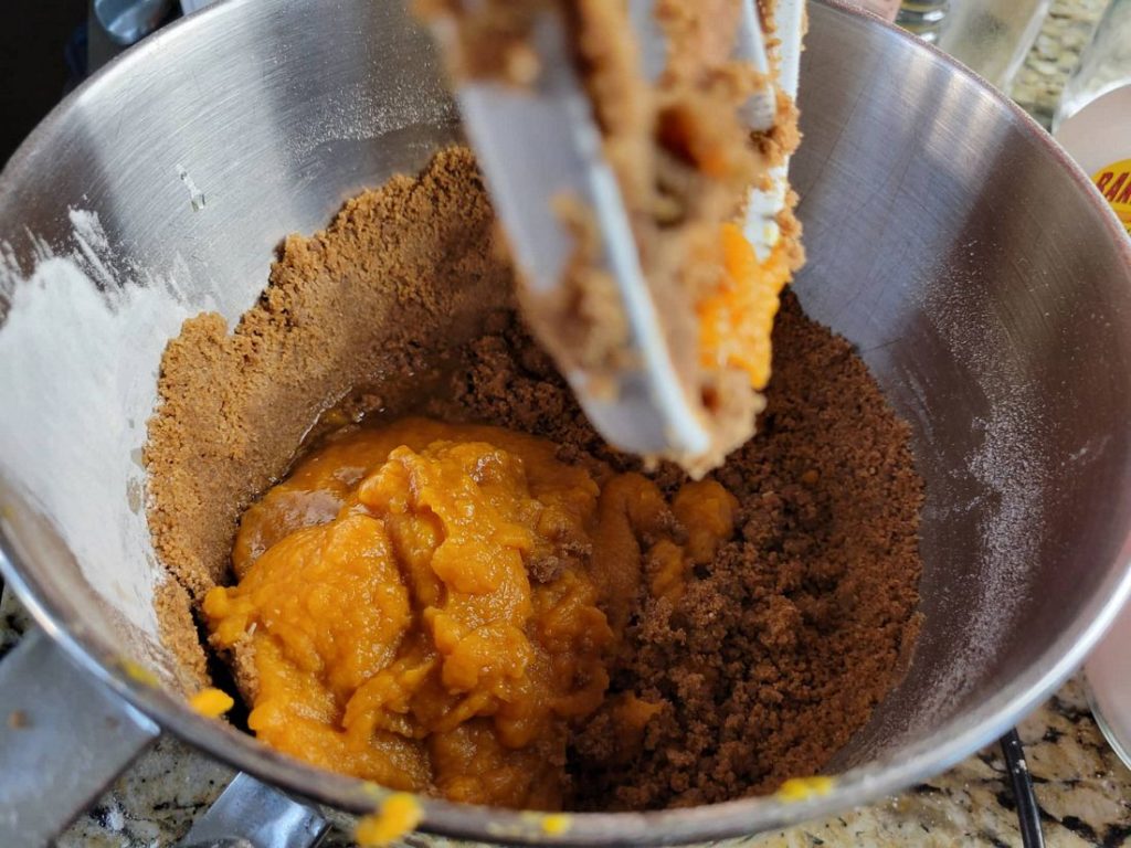 Adding in wet ingredients to the stand mixer for the pumpkin whoopie pies