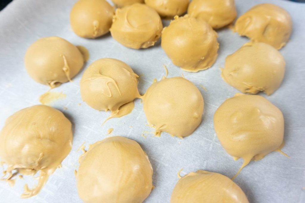 Peanut butter dough covered in melted peanut butter candy melts.