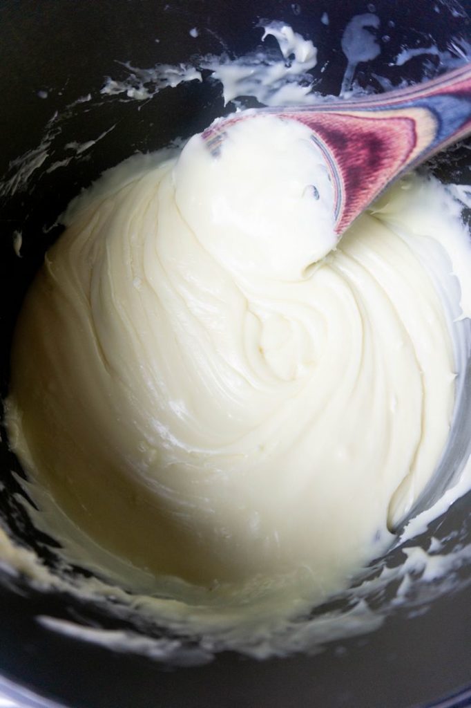 Melted chocolate and condensed milk in a sauce pan for fudge