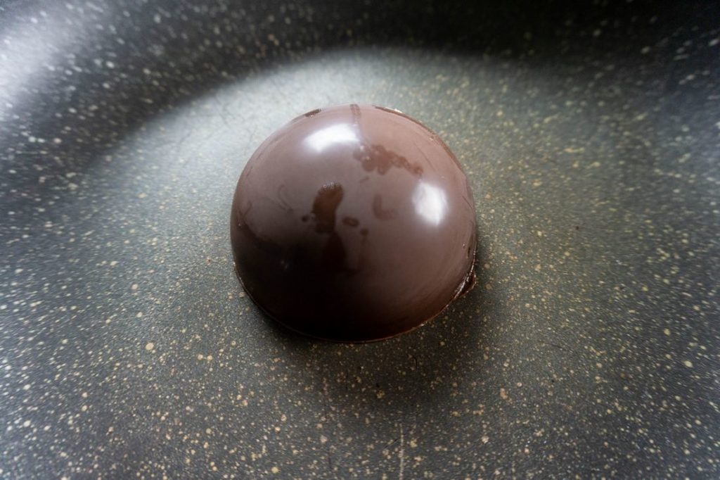 Heating chocolate dome in a pan to seal