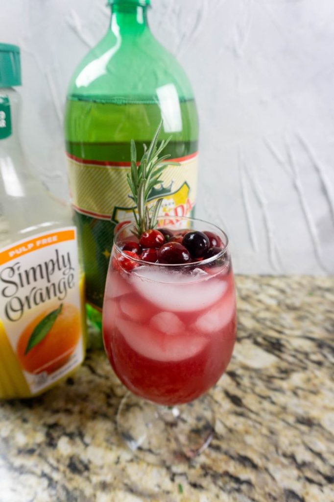 Ingredients like cranberry juice, orange juice, and ginger ale to make the Rudolph spritzer.