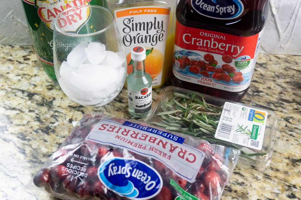 Ingredients like cranberry juice, orange juice, and ginger ale to make the Rudolph spritzer. 