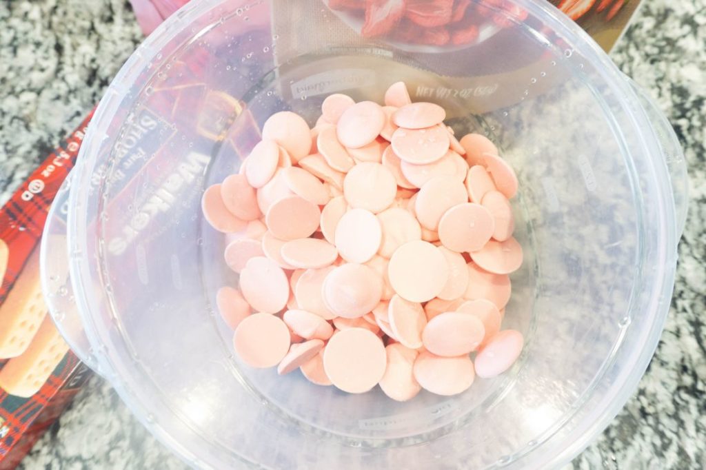 Pink candy melts in a bowl