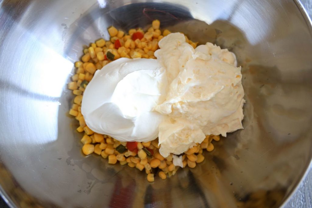 southwestern corn, mayo, and sour cream in a metal bowl