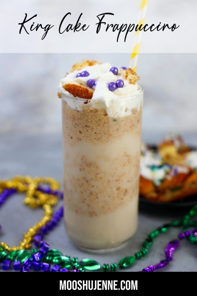 King Cake Frappuccino in a tall glass topped with whipped topping, purple pearl candies, and a yellow straw.