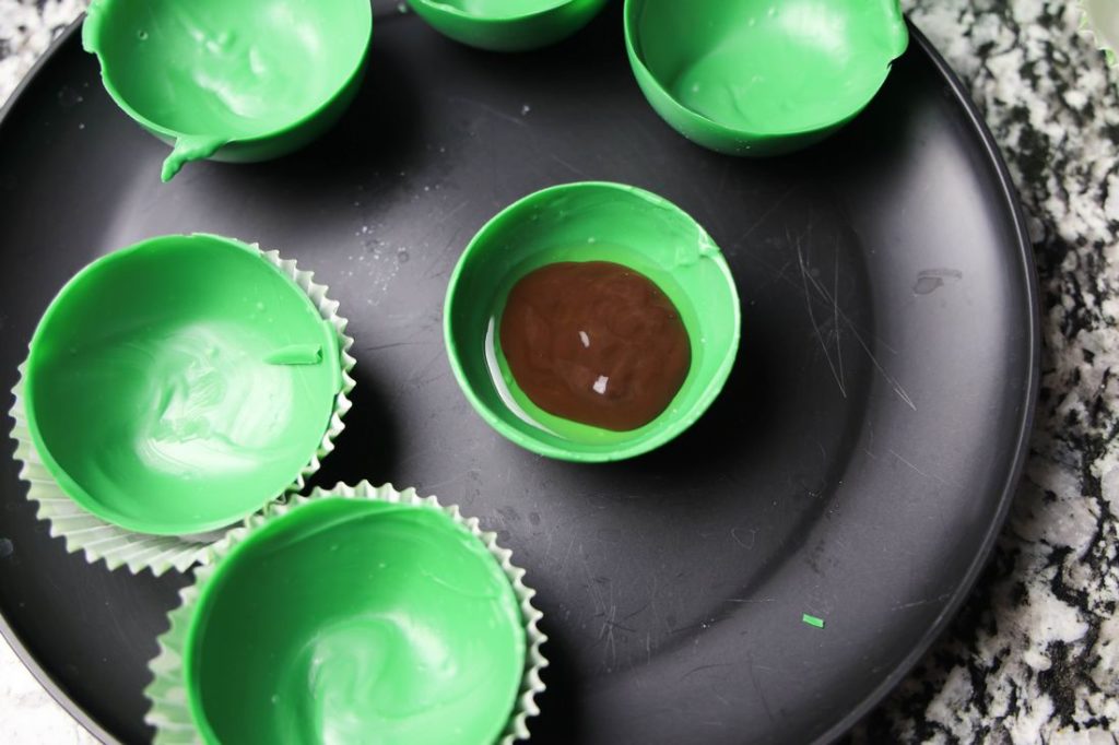 Chocolate sauce and whiskey inside the green bomb mold