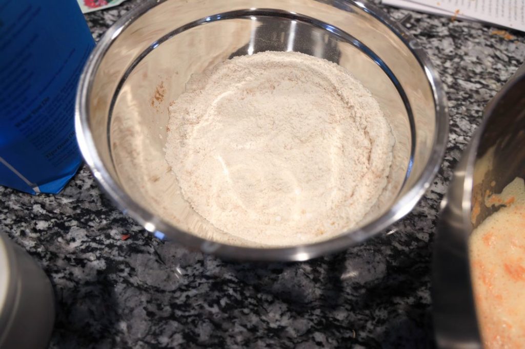 Dry ingredients for carrot cake roll in a metal bowl