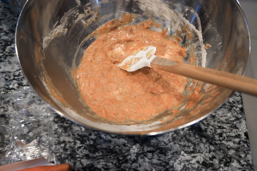 Mixed wet ingredients for carrot cake roll in a metal bowl