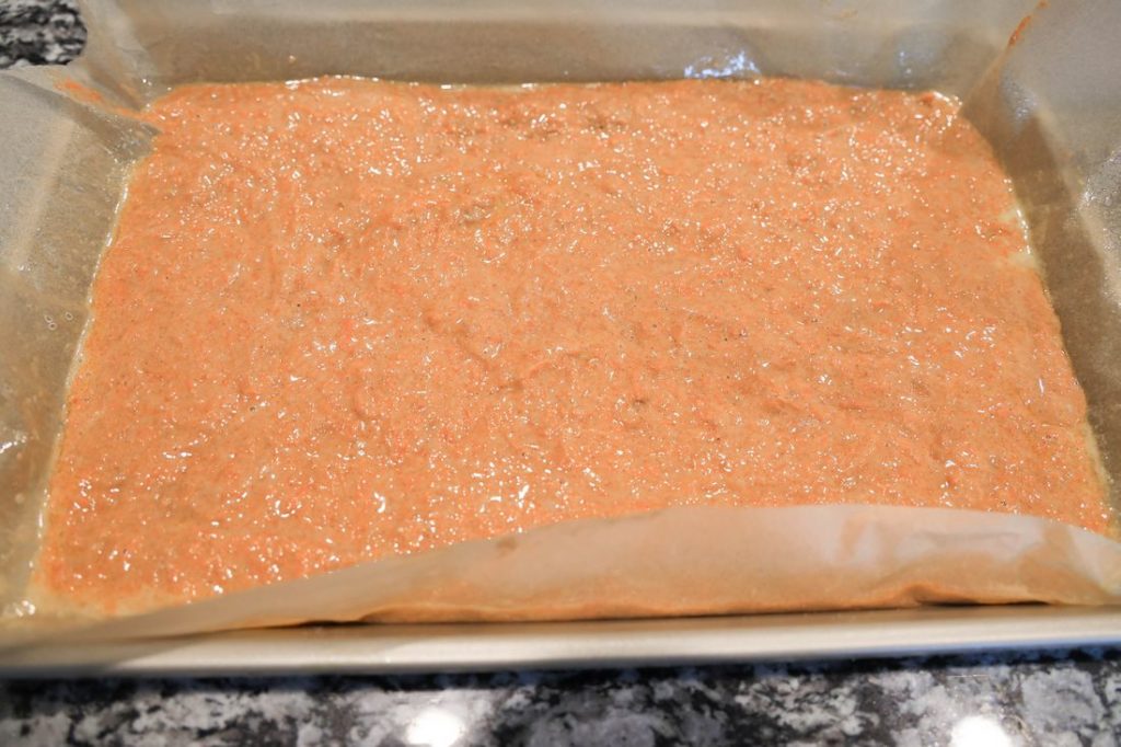 Carrot cake roll mixture on the jelly roll pan before baking