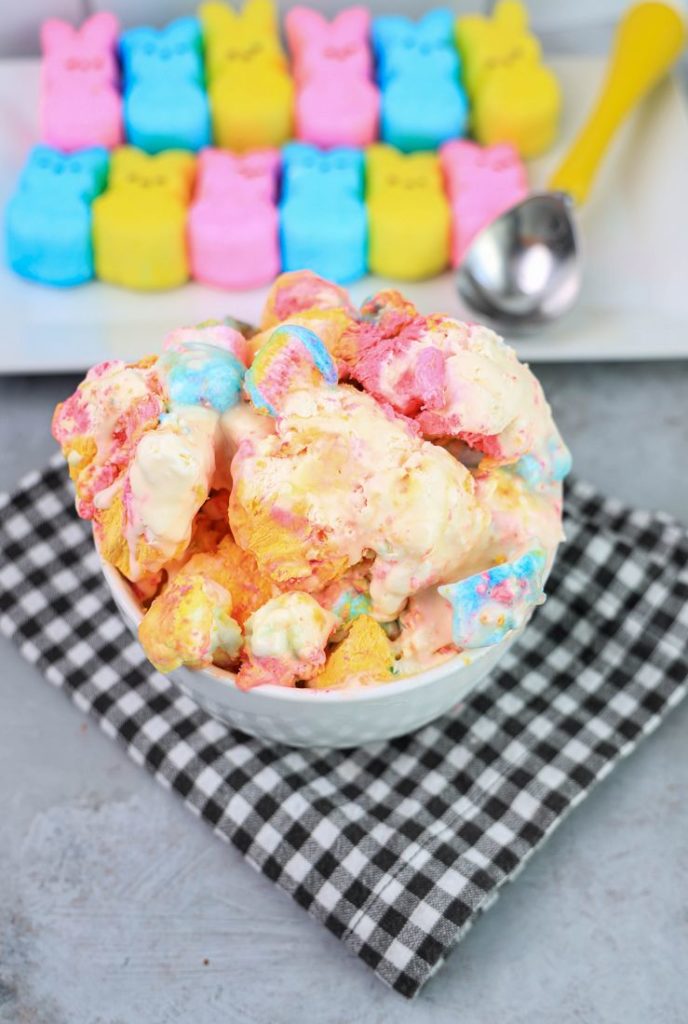 Peeps Ice Cream in a white bowl on a gray plaid napkin on a concrete backdrop