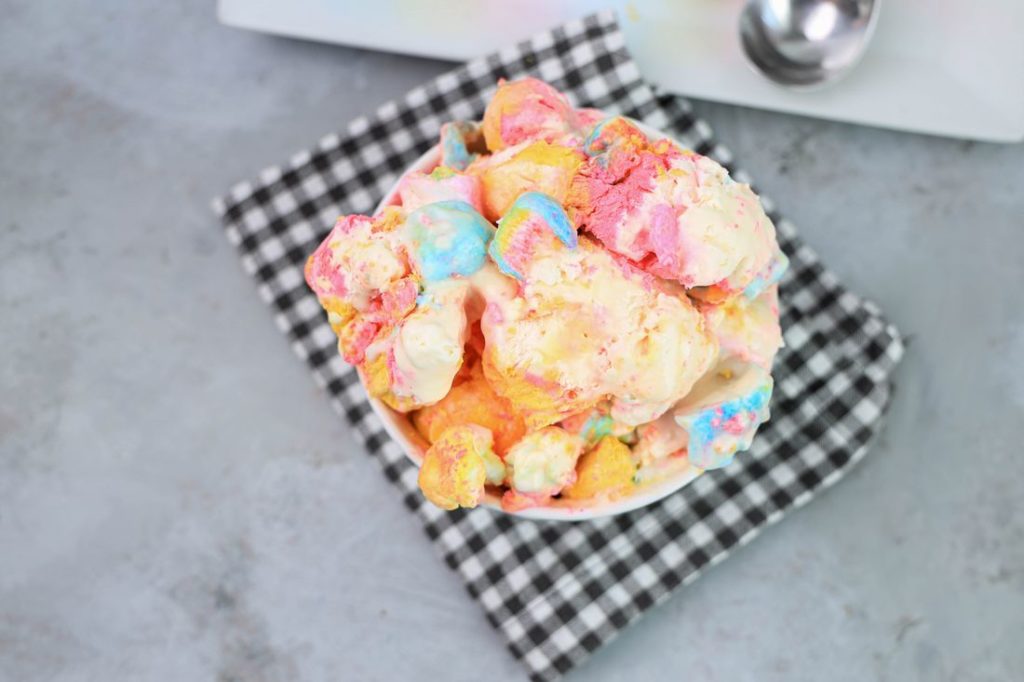 Peeps Ice Cream in a white bowl on a gray plaid napkin on a concrete backdrop