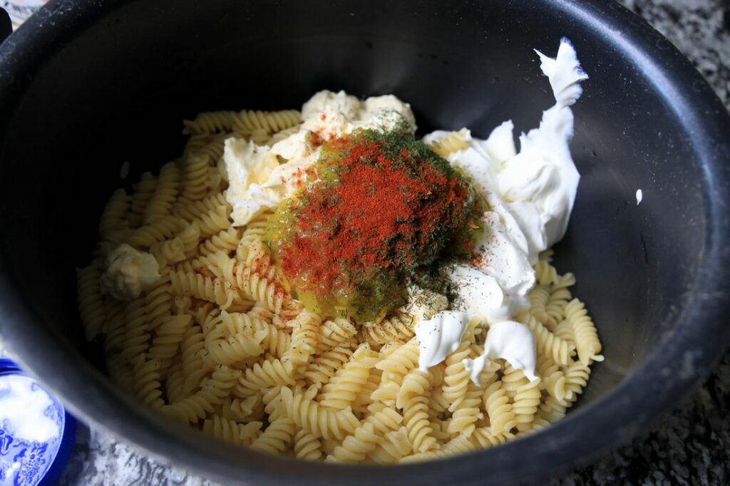 Pasta, sour cream, mayo, and spices in the pot.