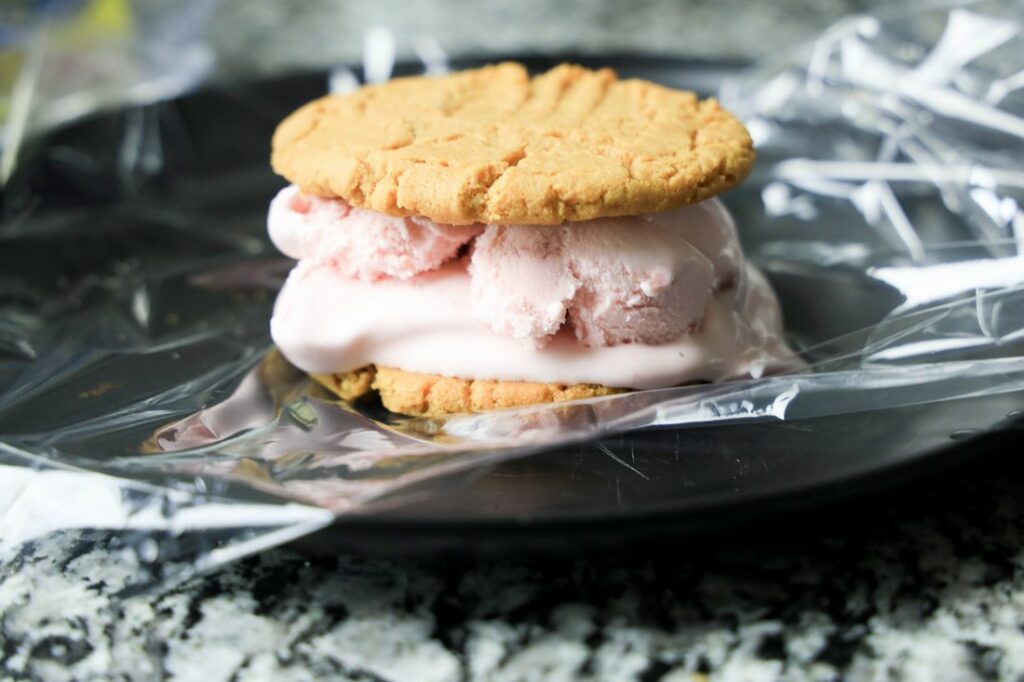 Peanut butter cookies filled with strawberry ice cream