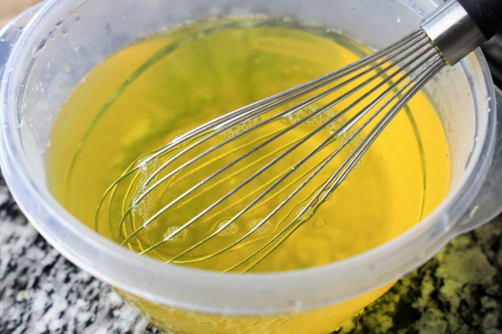 Pineapple Jello in a bowl with whisk