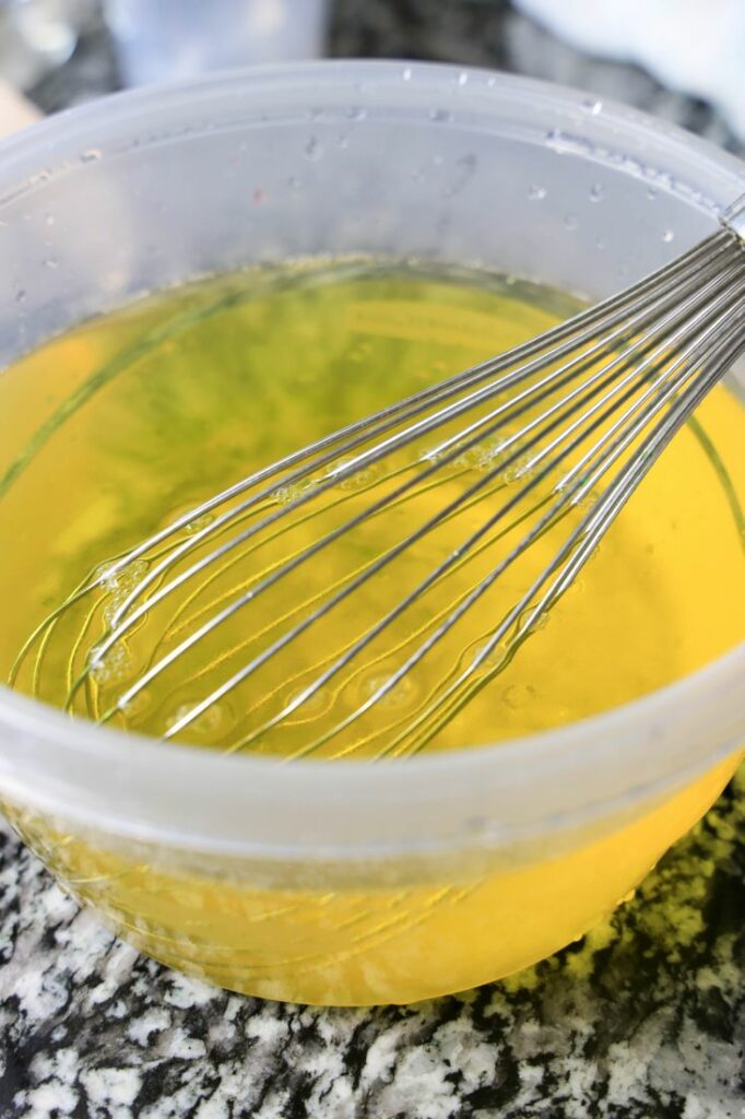 Pineapple Jello in a bowl with whisk