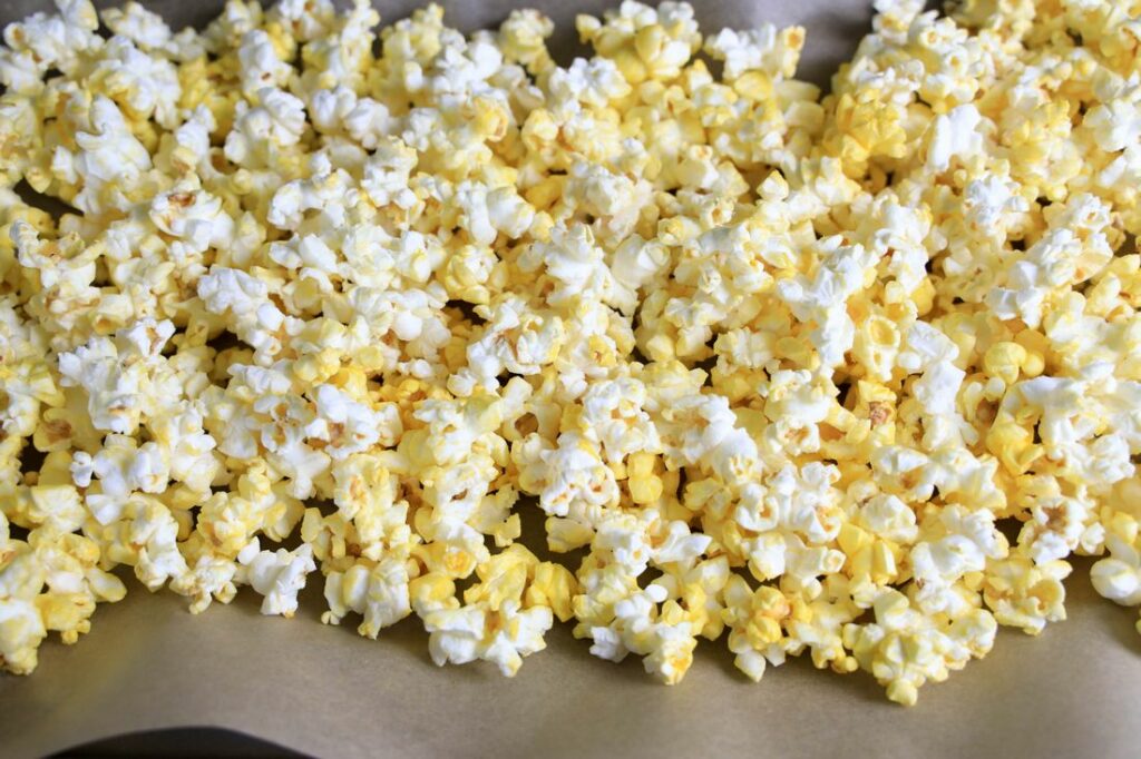 Popcorn on a tray of parchment paper.