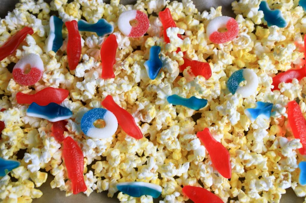 Popcorn and gummy candy added to the top