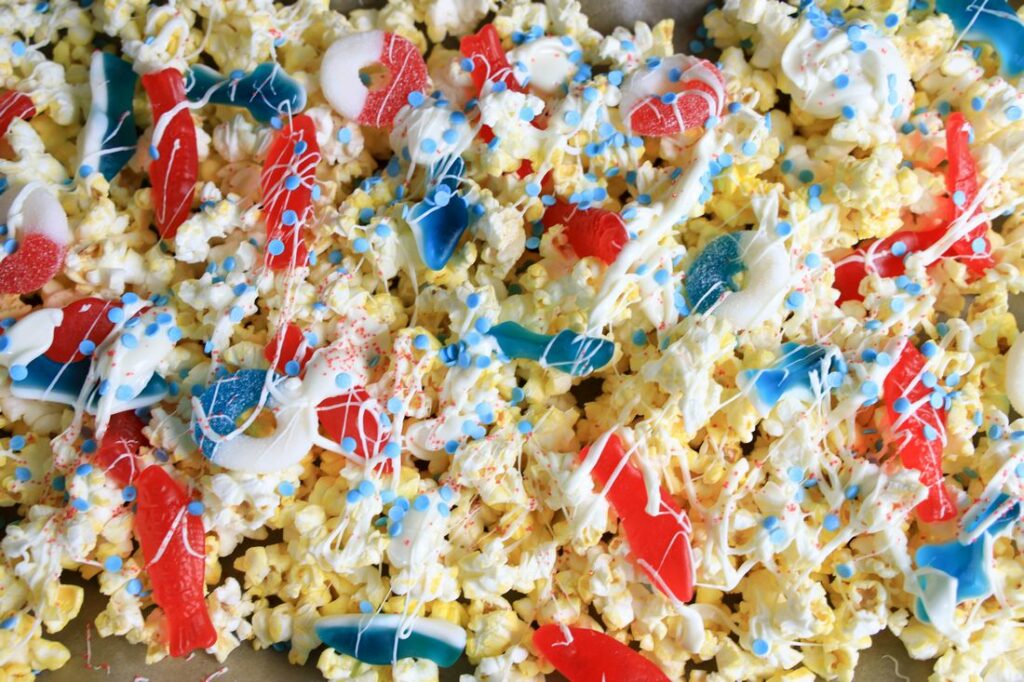 Popcorn with candy and white chocolate drizzle.