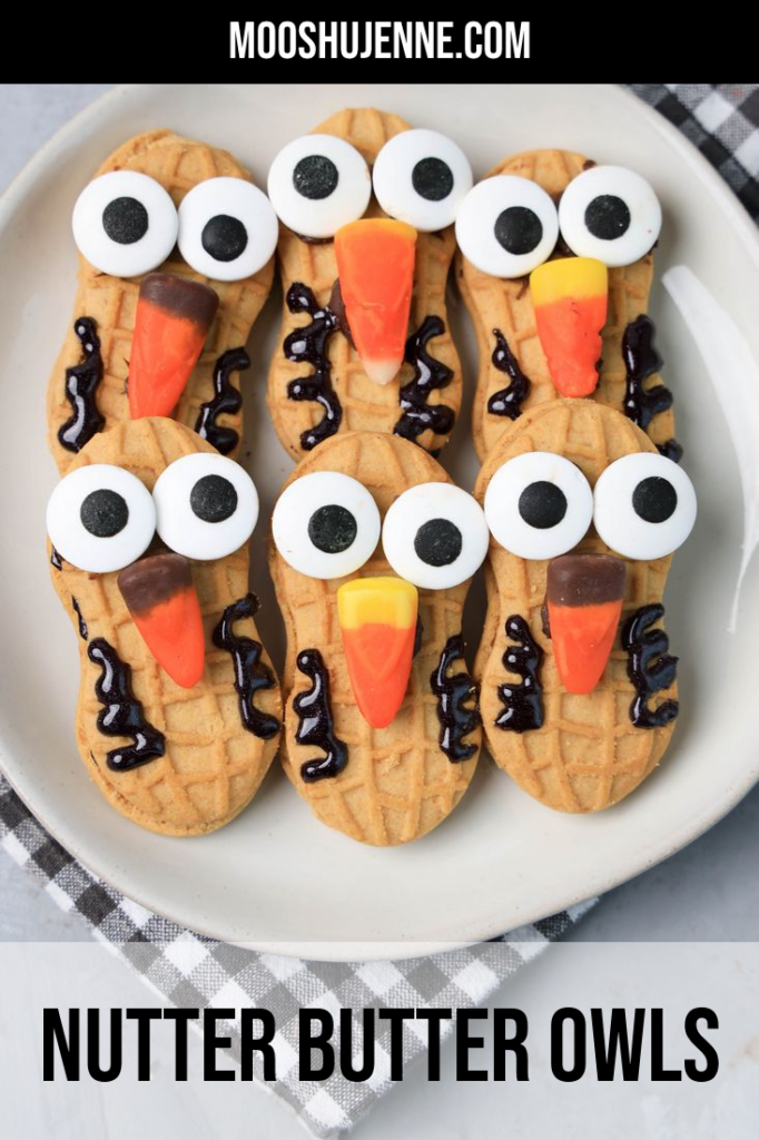 Nutter Butter Owls on a white plate on a plaid napkin with concrete backdrop