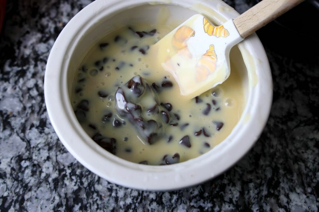 Chocolate and sweetened condensed milk in a stone colored bowl