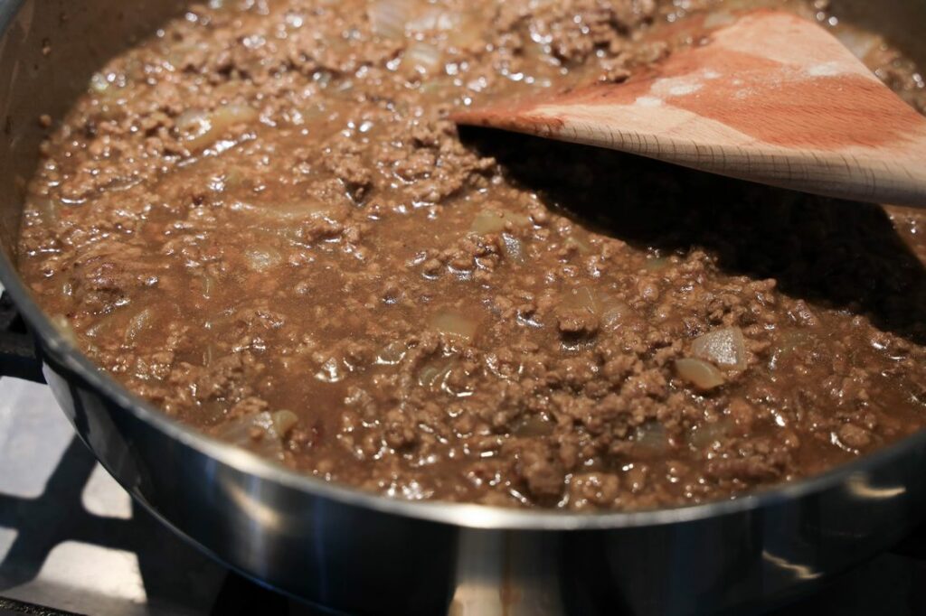 Gravy and ground beef in pan.