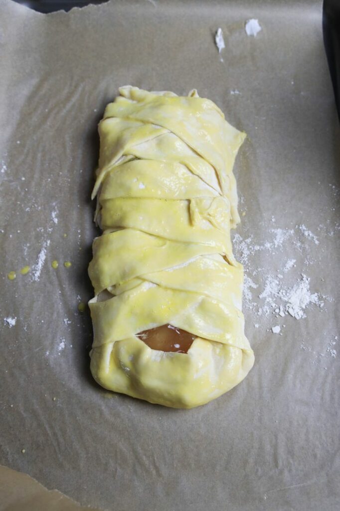 apple pie cream cheese braid that is braided and brushed with egg wash