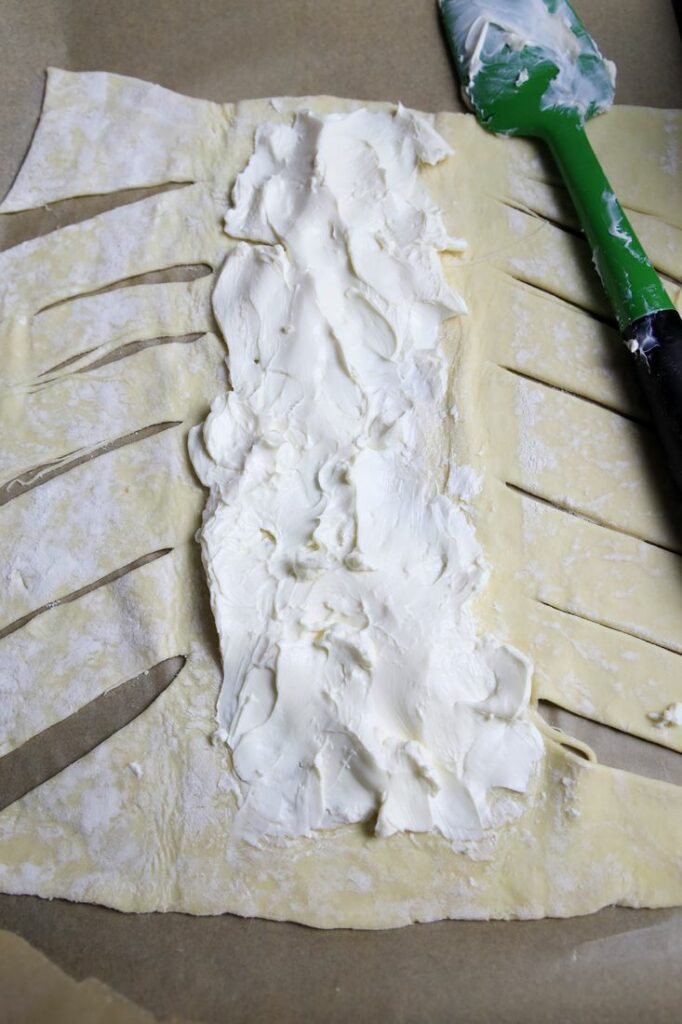 Puff Pastry cut on the sides to make a braid and a layer of cream cheese,