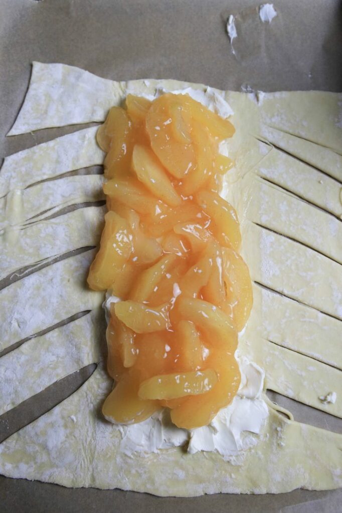 Puff Pastry cut on the sides to make a braid and a layer of cream cheese and apple pie filling.