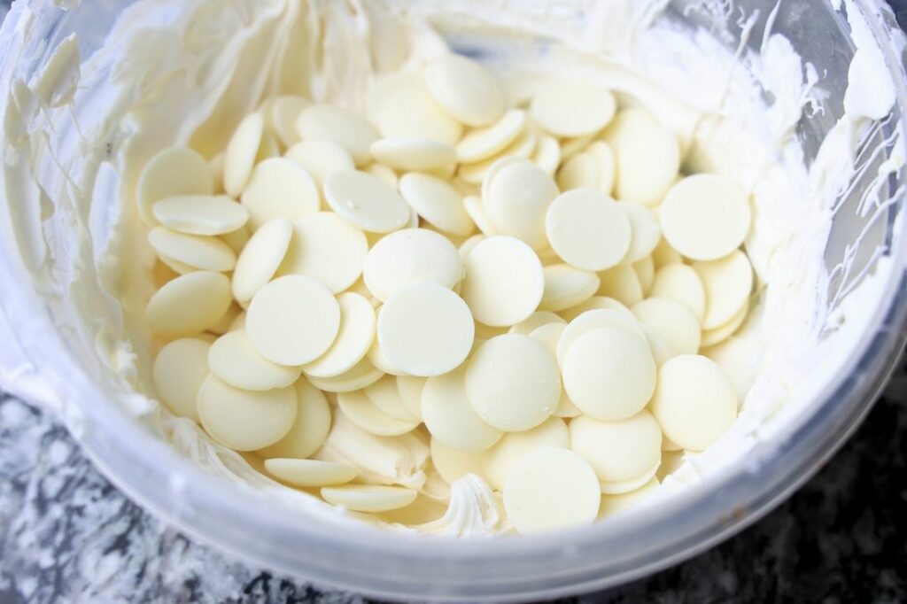 Ghirardelli's white chocolate wafers in a bowl.