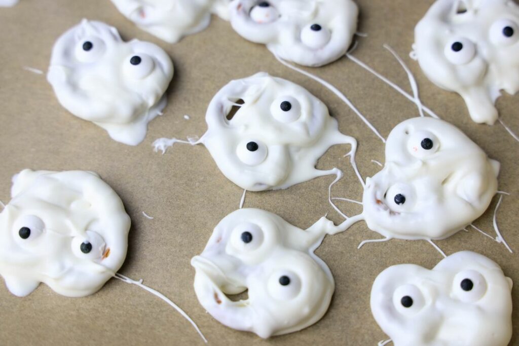 White chocolate covered pretzels with candy eyes.