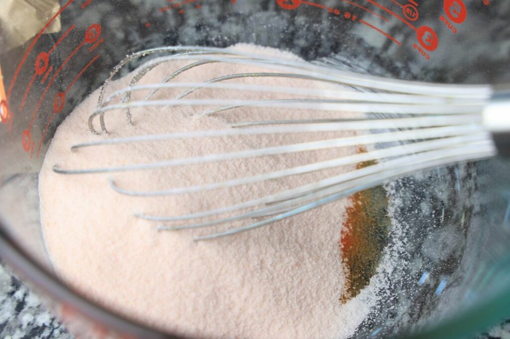 Orange jello powder in a bowl.